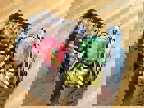 paper grocery bags with fruit, veg & bagels visible