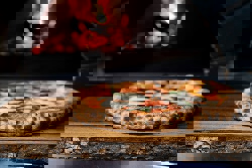 Woodfired pizza on an oak serving tray